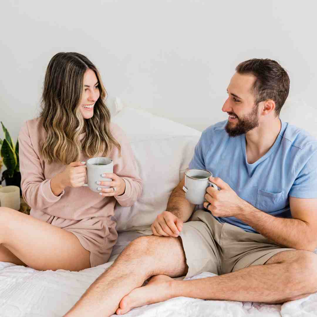 Couple having coffee together in bed.